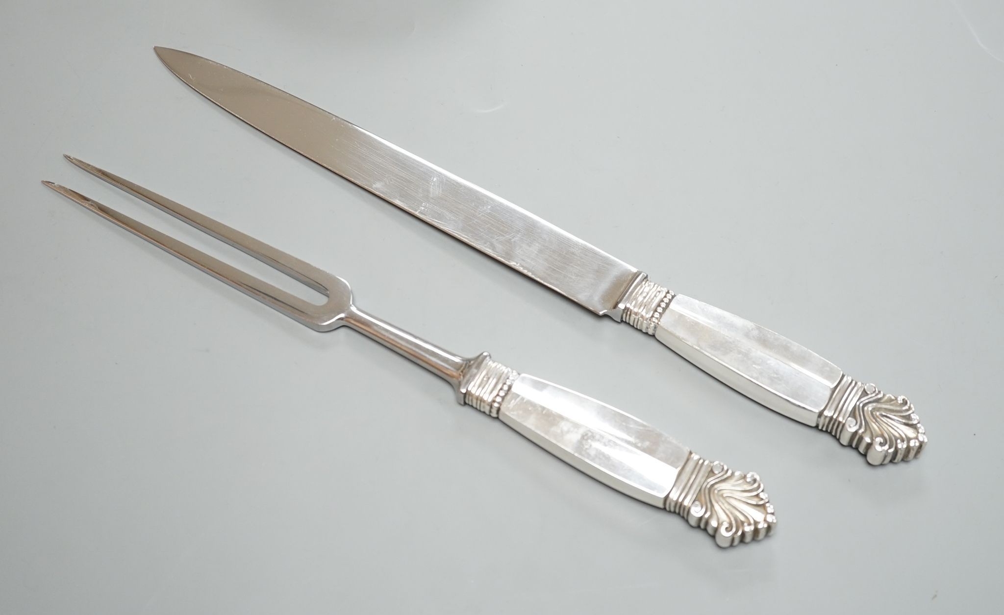 A pair of Georg Jensen sterling handled carving knife and fork, knife 34.4cm.